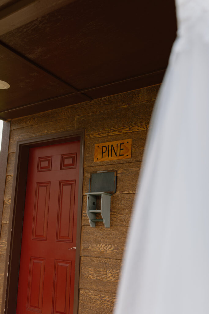 Close-up of cabin door labeled 'Pine' at Outbound Heli Adventures base near Palmer Valley, Alaska.