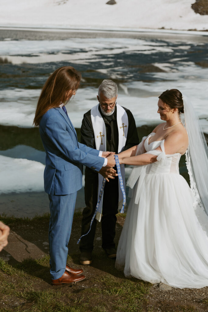 Bride and groom during a hand fasting ceremony at their Hatcher Pass elopement at Summit Lake Alaska