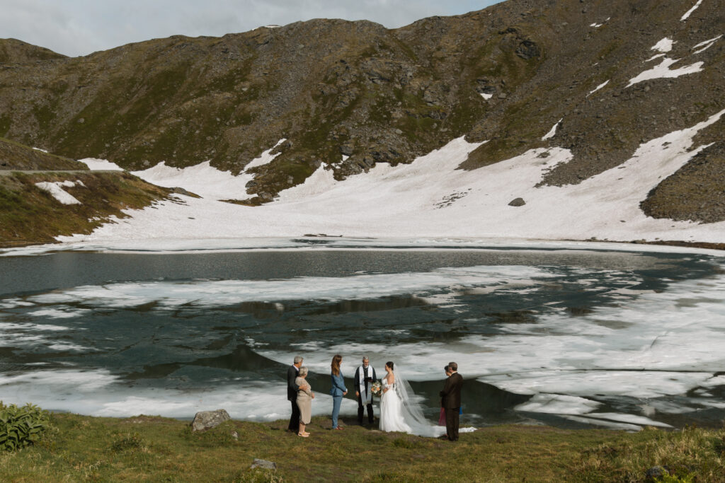 Bride and groom exchanging vows during their intimate Hatcher Pass elopement ceremony at Summit Lake Alaska