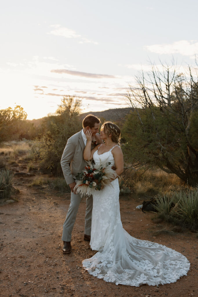 Bride touching groom's face with foreheads close together during their Sedona Arizona elopement at Secret Slickrock
