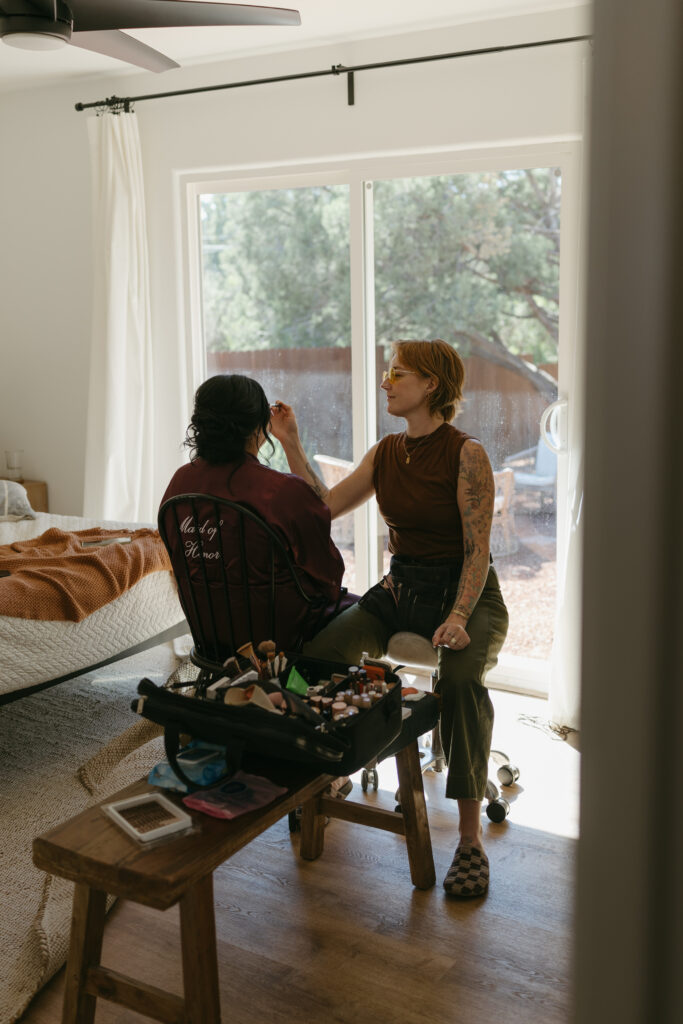 Desert Sage Hair and Makeup artist doing bridesmaid makeup at a Sedona Arizona Airbnb during elopement morning getting ready