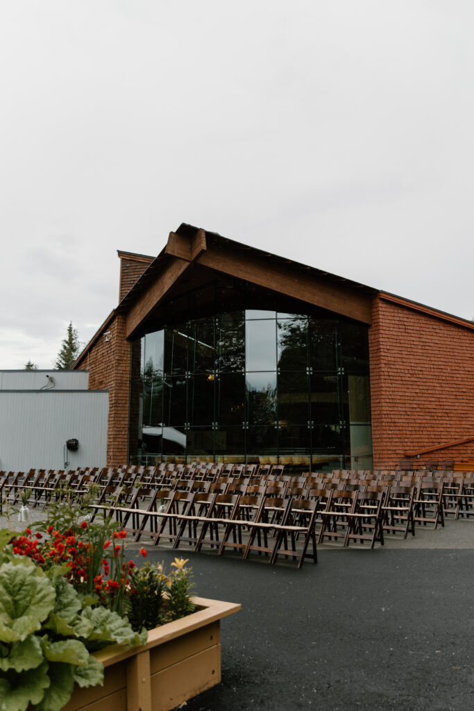 Wedding ceremony chairs set up in front of the glass museum building at the Alaska Native Heritage Center in Anchorage Alaska