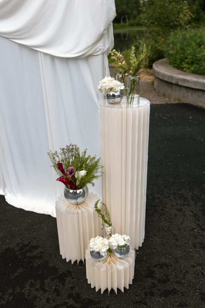 Ceremony pedestals decorated with disco balls and flowers