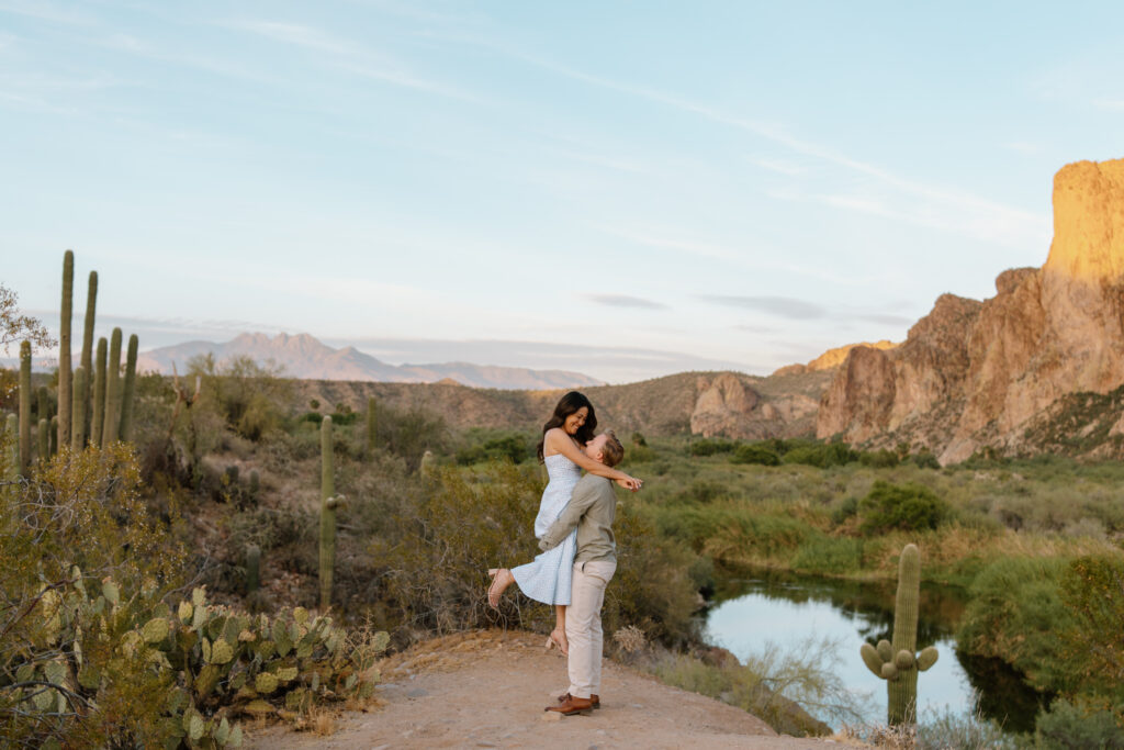 Man picks up fiance and twirls her near the Salt River Arizona