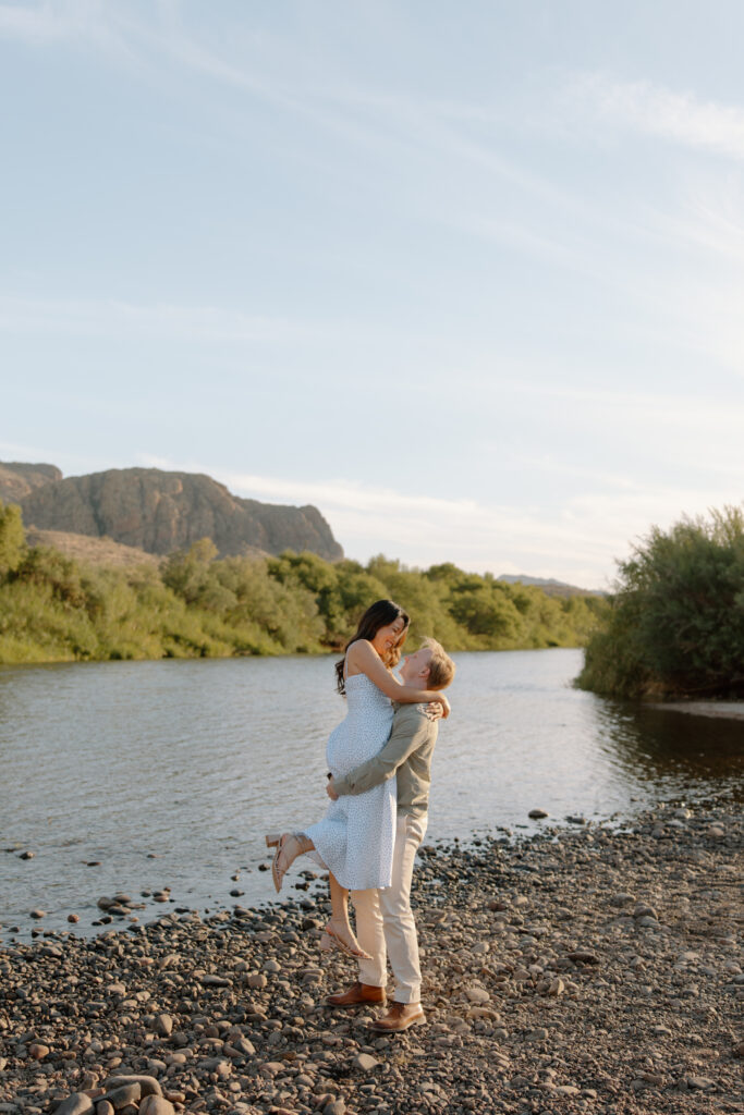 Man picks up fiance and twirls her near the Salt River Arizona