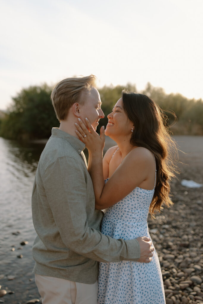 Couple embracing and smiling together at the overlook during a Salt River engagement session